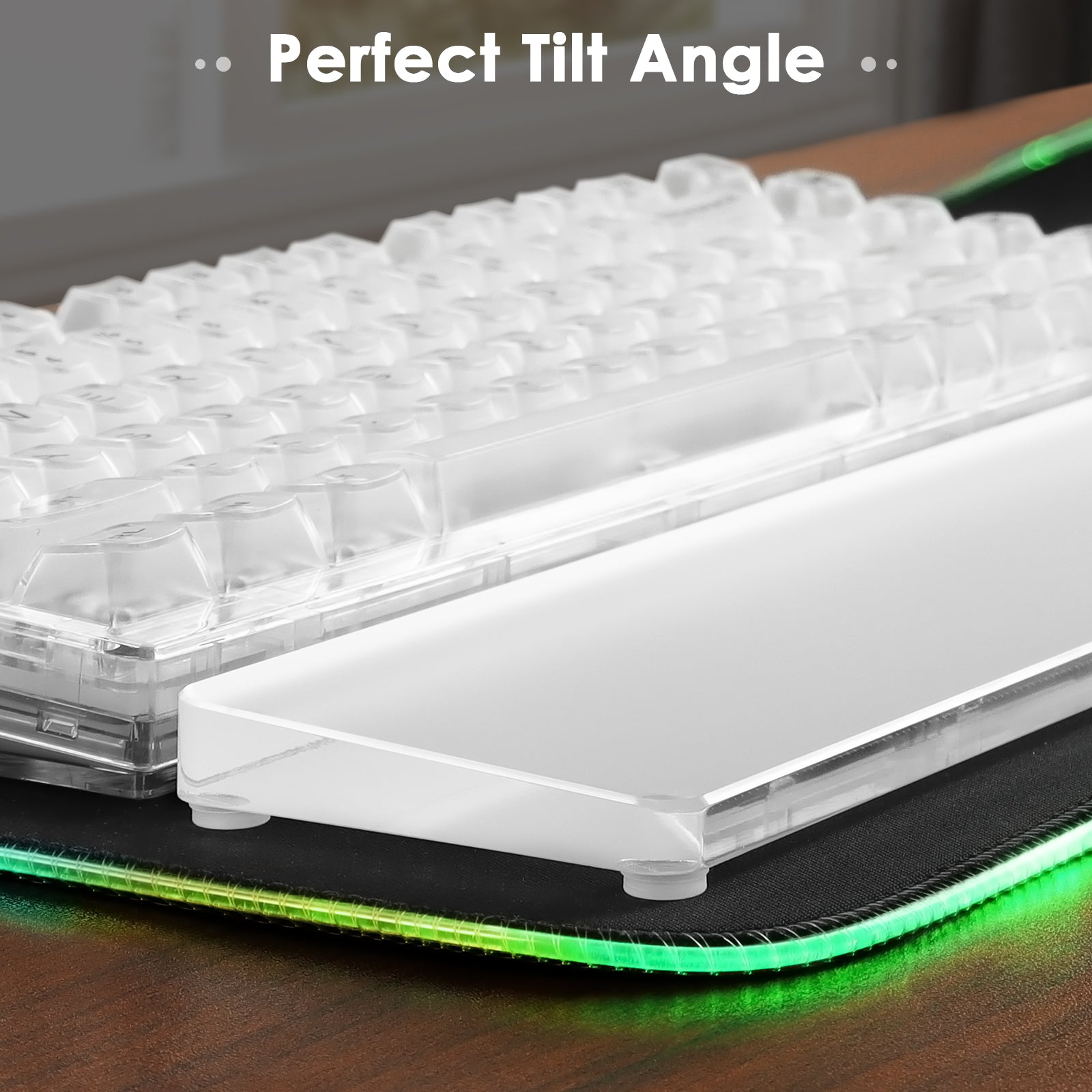 Acrylic wrist rest at perfect tilt angle beside a clear mechanical keyboard.