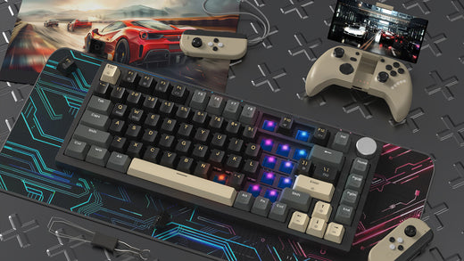 Gaming setup featuring a compact mechanical keyboard with RGB lighting and beige accent keys on a gaming mousepad with blue and red circuit design